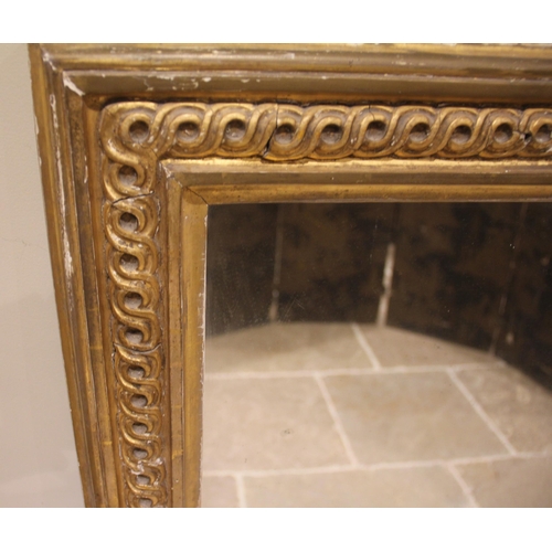 797 - A Victorian giltwood and gesso overmantel wall mirror, the single mirror plate enclosed within a gil... 