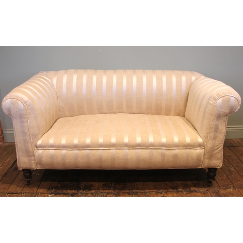 1014 - An Edwardian drop-end Chesterfield type sofa, later re-covered in striped ivory coloured fabric, the... 