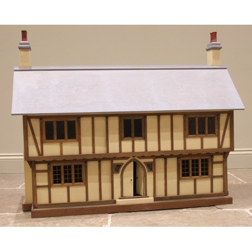 676 - A scratch built mock Tudor dolls house, the removable front panel and hinged roof opening to an arra... 