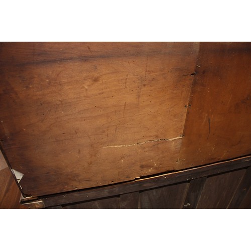 941 - A late 19th century oak housekeepers cupboard, the moulded cornice over four panelled doors, upon th... 