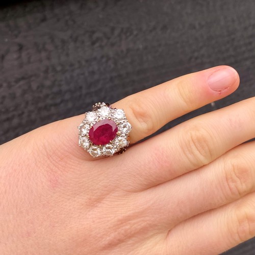 267 - An Edwardian style untested ruby and diamond ring, the central oval cut untested ruby within surroun... 