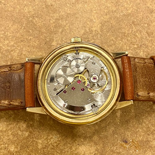 166 - A 9ct gold cased Garrard wristwatch, the silver coloured dial with baton markers, set to plain polis... 