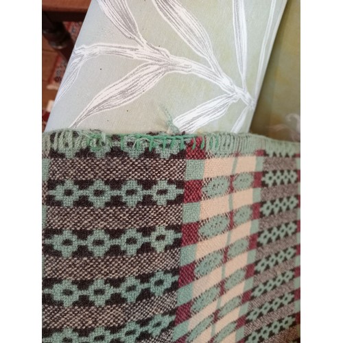 647 - A woollen Welsh blanket, in sage green, pink and oatmeal colourways, with a traditional geometric an... 