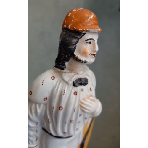 614 - A Staffordshire pottery flatback figure of a cricketer, 19th century, 26cm high (at fault)