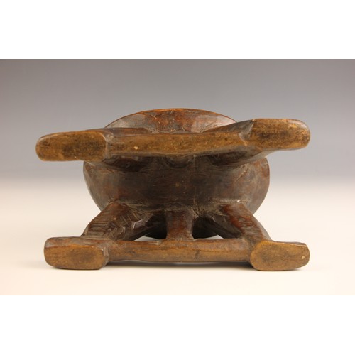 504 - A South Sudanese stool, Bongo People, early 20th century, the oval platform raised on four curved le... 