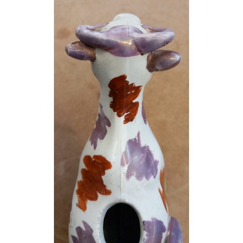 607 - An English pottery cow creamer, Yorkshire, 19th century, with lustre decoration, modelled standing o... 