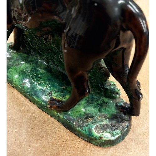 569 - Two French majolica greyhounds, 19th century, each modelled standing against a rough bocage support ... 