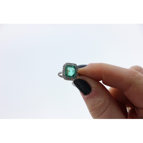 255 - An early 20th century untested emerald and diamond cluster ring, the central emerald cut emerald wit... 