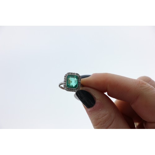 255 - An early 20th century untested emerald and diamond cluster ring, the central emerald cut emerald wit... 