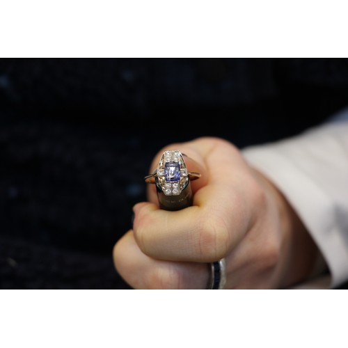 304 - An Art Deco style untested sapphire ring, the central round cut untested sapphire within surround of... 