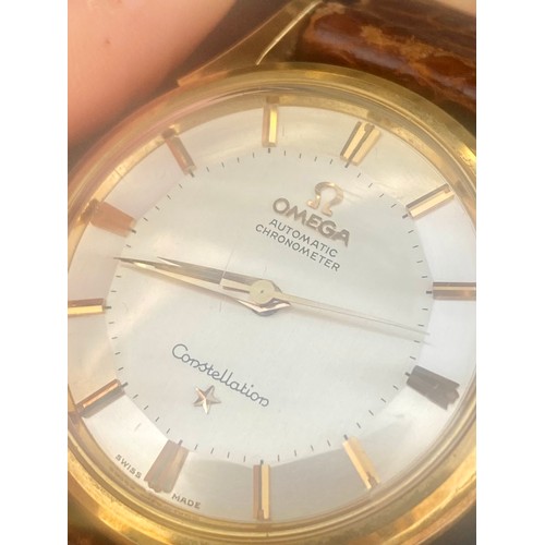 169 - A yellow metal cased Omega Automatic Chronometer Constellation wristwatch, the circular silver colou... 