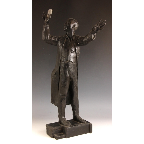 142 - John W Mills (1933-2023),  
Scientist holding a lens to the light,    
Patinated resin on integral b... 