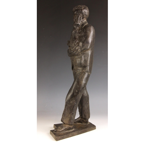 143 - John W Mills (1933-2023),  
Schoolboy carrying books,  
Patinated resin on integral base,  
50.5cm h... 