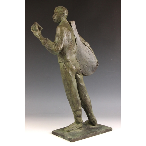 145 - John W Mills (1933-2023),  
Musician reading a book, left hand,  
Patinated resin on integral base, ... 