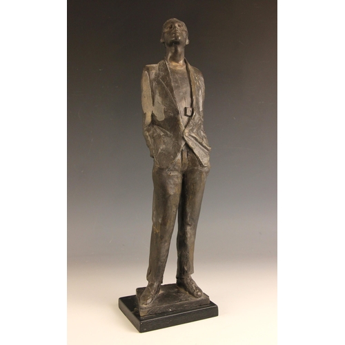 174 - John W Mills (1933-2023),  
Man with hands in pockets looking up,    
Patinated cold cast bronze on ... 