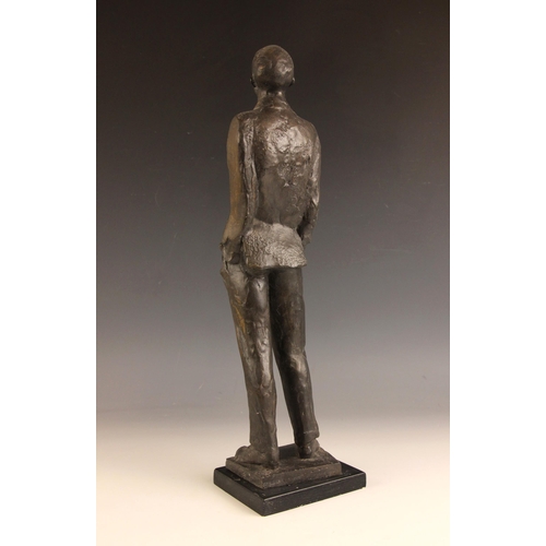 174 - John W Mills (1933-2023),  
Man with hands in pockets looking up,    
Patinated cold cast bronze on ... 