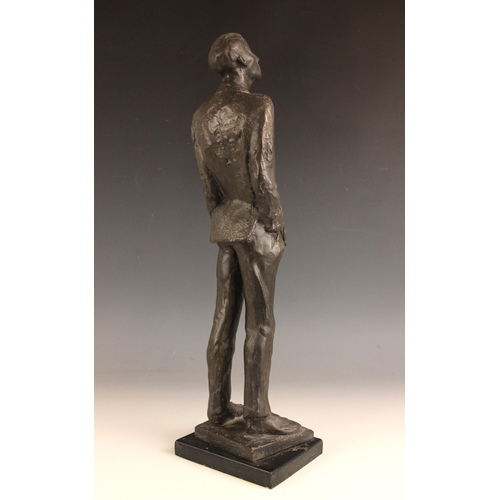 174 - John W Mills (1933-2023),  
Man with hands in pockets looking up,    
Patinated cold cast bronze on ... 