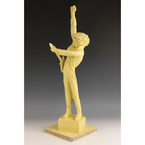 176 - John W. Mills (1933-2023),   
Brian May playing guitar (leg down),  
Painted resin on stepped base, ... 