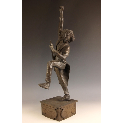 180 - John W. Mills (1933-2023),   
Brian May playing guitar (leg raised) #2,  
Patinated cold cast bronze... 