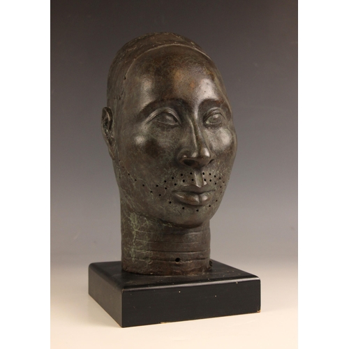 534 - Nigerian Ife head,  
Patinated bronze on ebonised stand,  
30cm high overall