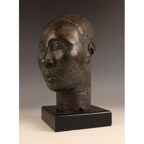 534 - Nigerian Ife head,  
Patinated bronze on ebonised stand,  
30cm high overall