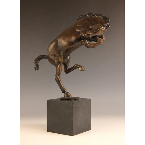 538 - Rearing mustang,  
Patinated bronze on wooden stand,  
Indistinctly signed,  
38cm high