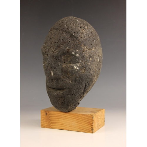 548 - Carved tribal head,  
Volcanic rock on wooden base,  
26cm high overall