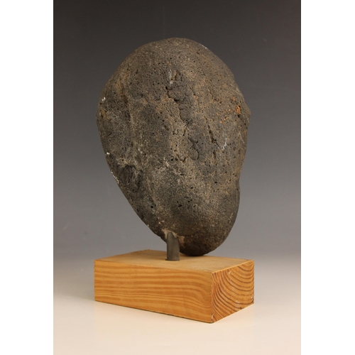 548 - Carved tribal head,  
Volcanic rock on wooden base,  
26cm high overall