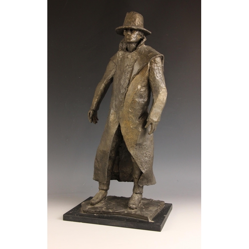 134 - John W Mills (1933-2023),  
Man in Sou'wester,  
Patinated cold cast bronze on ebonised base,  
62cm... 