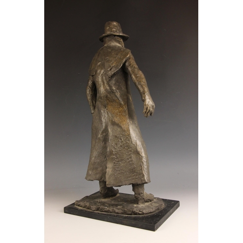 134 - John W Mills (1933-2023),  
Man in Sou'wester,  
Patinated cold cast bronze on ebonised base,  
62cm... 