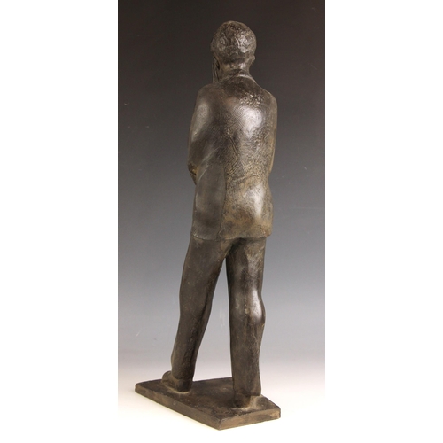 143 - John W Mills (1933-2023),  
Schoolboy carrying books,  
Patinated resin on integral base,  
50.5cm h... 