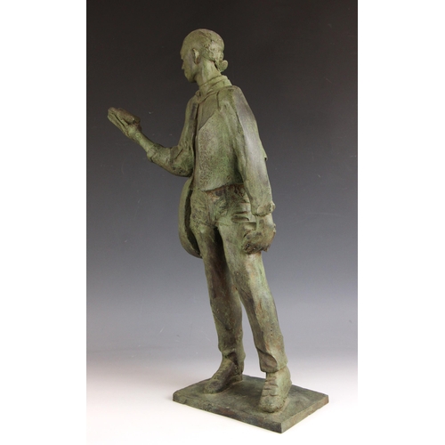 151 - John W Mills (1933-2023),  
Musician reading and holding books,  
Patinated resin on integral base, ... 