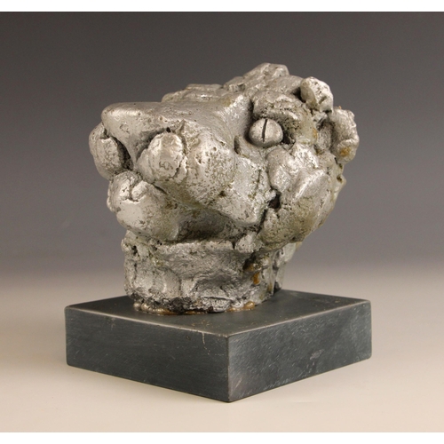 443 - John W Mills (1933-2023),   
Lion’s mask,     
Painted composite clay on slate base,   
14cm high ov... 