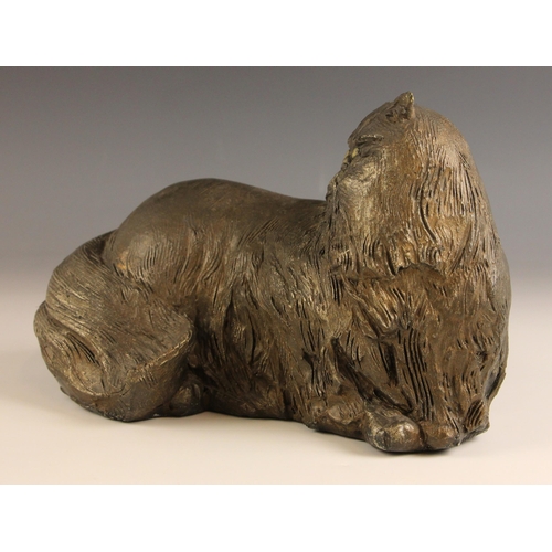 462 - John W Mills (1933-2023),   
Chloe,  
Recumbent cat, head turned,   
Patinated resin, freestanding, ... 