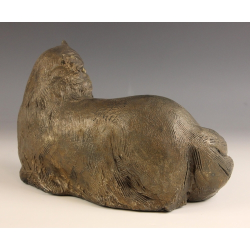 462 - John W Mills (1933-2023),   
Chloe,  
Recumbent cat, head turned,   
Patinated resin, freestanding, ... 