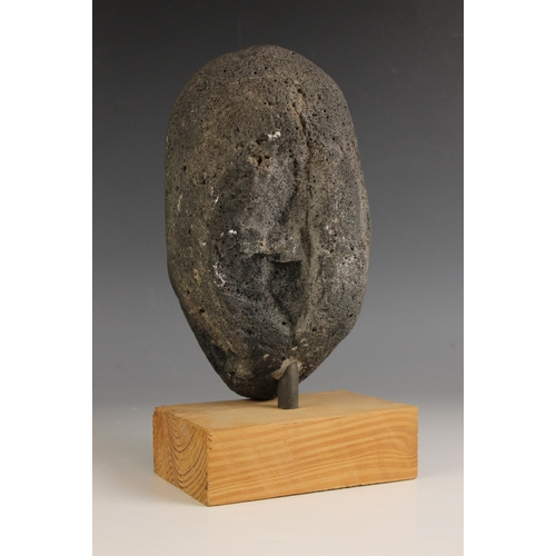 548 - Carved tribal head,  
Volcanic rock on wooden base,  
26cm high overall