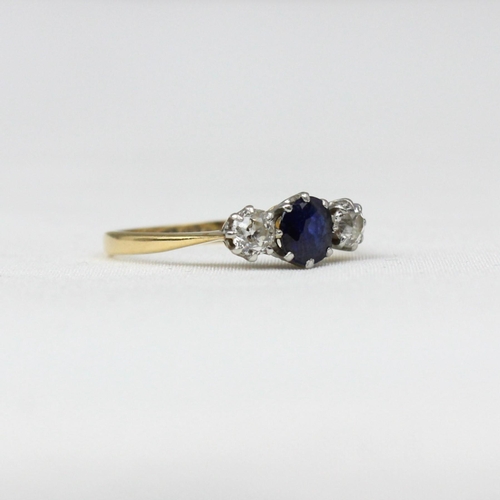 180 - An early/mid 20th century sapphire and diamond three stone ring, the central cushion cut sapphire wi... 