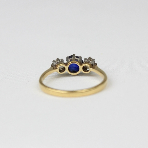 180 - An early/mid 20th century sapphire and diamond three stone ring, the central cushion cut sapphire wi... 