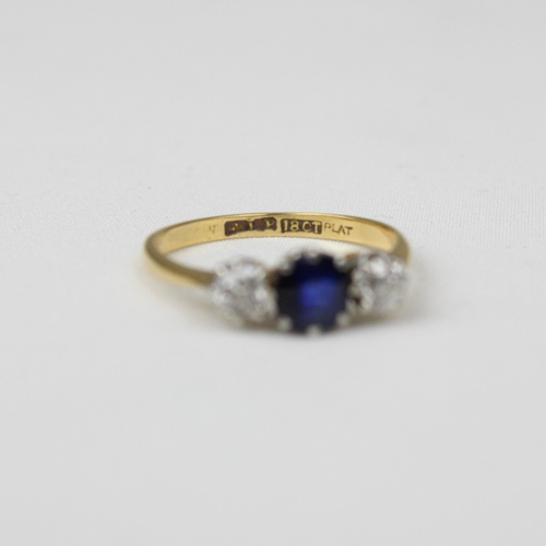 180 - An early/mid 20th century sapphire and diamond three stone ring, the central cushion cut sapphire wi... 