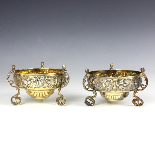 26 - A pair of Edwardian silver gilt bowls, Daniel & John Wellby, London 1906, the florally embossed bowl... 