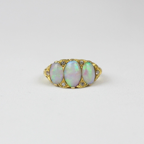 337 - A late 19th century opal three stone ring, the three graduated oval opal cabochons with rose cut dia... 