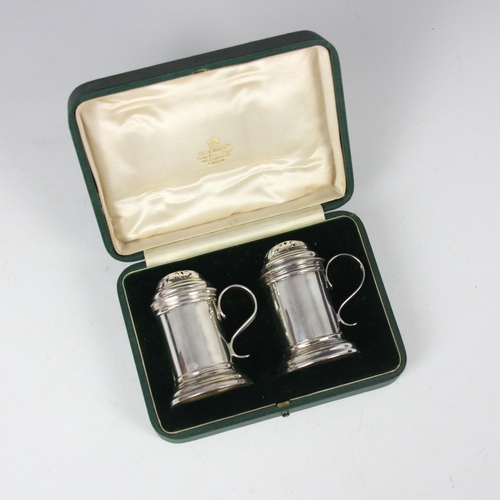 37 - A cased pair of Edwardian Britannia standard silver pepperettes, Charles Stuart Harris, London 1903,... 