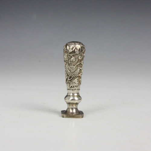 72 - A late 19th century Chinese white metal desk seal, possibly Canton, the tapered embossed handle deco... 