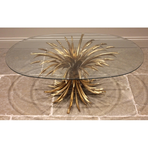 1003 - A Hollywood Regency gilt metal coffee/centre table, mid 20th century, the bevelled oval glass top up... 