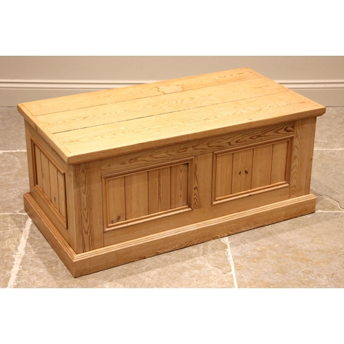 1006 - A contemporary pine storage chest, the hinged top over bead moulded panelled sides and a plinth base... 