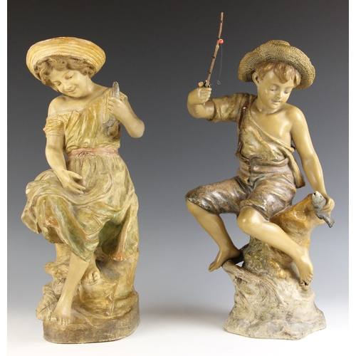 519 - A pair of Goldscheider cold painted terracotta figures, early 20th century, modelled as a boy and gi... 