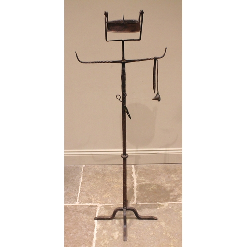 773 - A 19th century freestanding iron pricket candle stand, possibly continental, with a swing candle wel... 