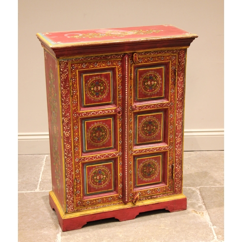 996 - A painted Indian hardwood cabinet, finished in vibrant red and yellow colourways, the pair of three ... 