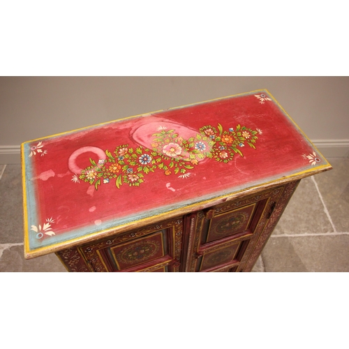 996 - A painted Indian hardwood cabinet, finished in vibrant red and yellow colourways, the pair of three ... 