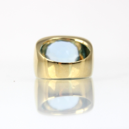 163 - A 'Fred' Paris 18ct yellow gold untested blue topaz dress ring, the oval mixed cut blue stone within... 